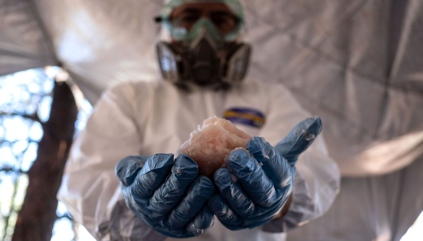 Mans in protective hazmat suit, blue sky Stock Photo by