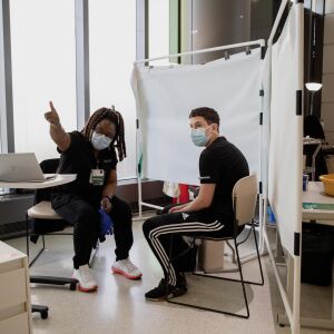 Henrietta Nkemeh talks to Christian Clettenberg, 15, before inoculating him with a COVID-19 vaccine at the Rush University Medical Center in the Illinois Medical District, Thursday morning, May 13, 2021. Kids as young as 12 became eligible for the COVID-19 vaccine Thursday. | Pat Nabong/Sun-Times
