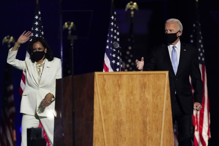 President-elect Joe Biden and Vice President-elect Kamala Harris wave to the crowd Saturday in Wilmington, Del.