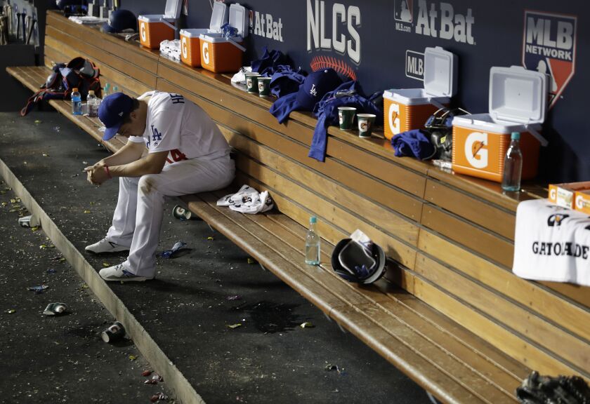 <em>The Dodgers’ Kike Hernandez sits in the dugout during the eighth inning of Game 4 of the NLCS in Los Angeles. (AP)</em>