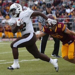 Mount Carmel’s Demetrias Rias (22) breaks through the line. Allen Cunningham/For the Sun-Times.