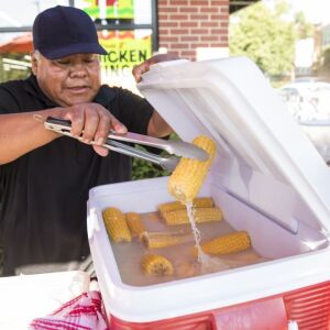 Felipe Vallarta, 58, an elotero, serves corn from his stand at the intersection of Clark and Rogers in Rogers Park, Sunday afternoon, June 24, 2018. | Ashlee Rezin/Sun-Times
