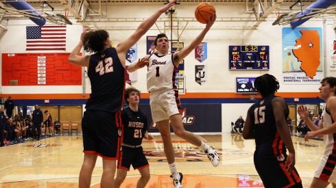 Benet’s Sam Driscoll (1) slashes through the lane to score against Oak Park.