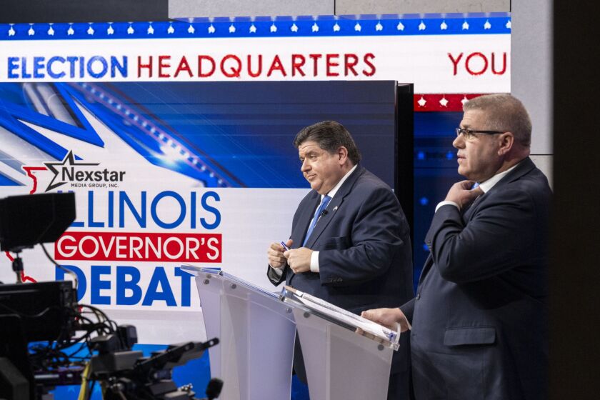 Gov. J.B. Pritzker (left) and GOP rival Darren Bailey prepare to debate on Oct. 18.