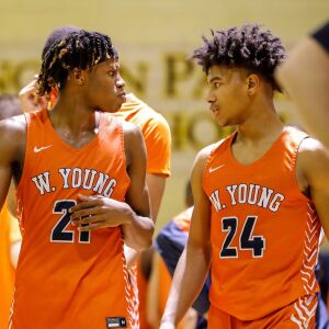 Young’s DJ Steward (21) and Jaehshon Thomas (24) interact during the game against Lincoln Park.