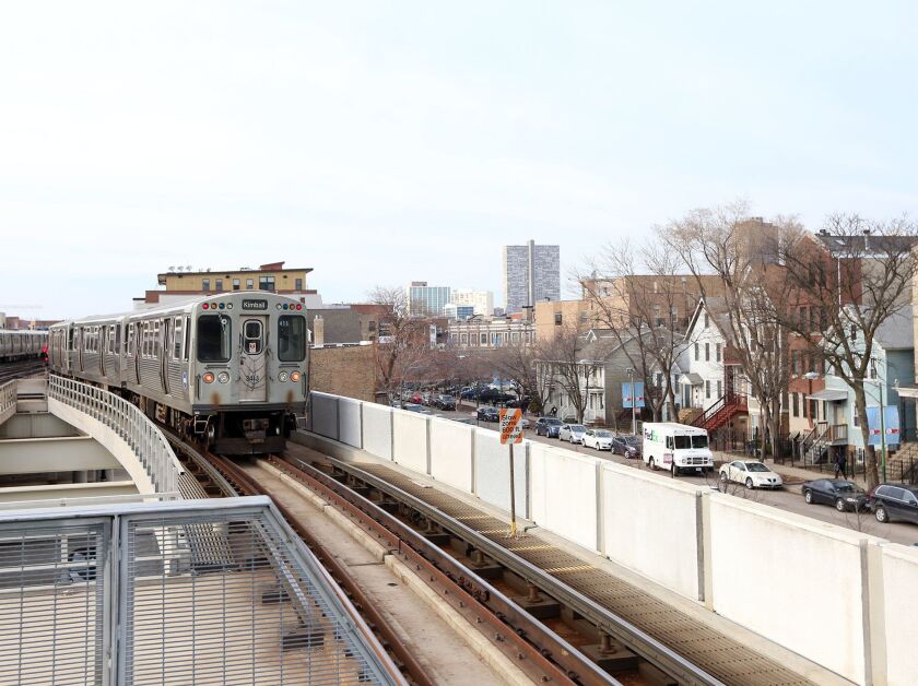 A northbound Brown Line train leaves the Belmont station.