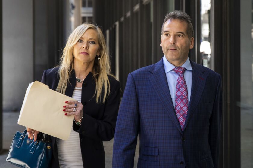 Vincent DelGiudice (right) walks with his attorney, Carolyn Gurland, out of the Dirksen Federal Courthouse Wednesday morning.