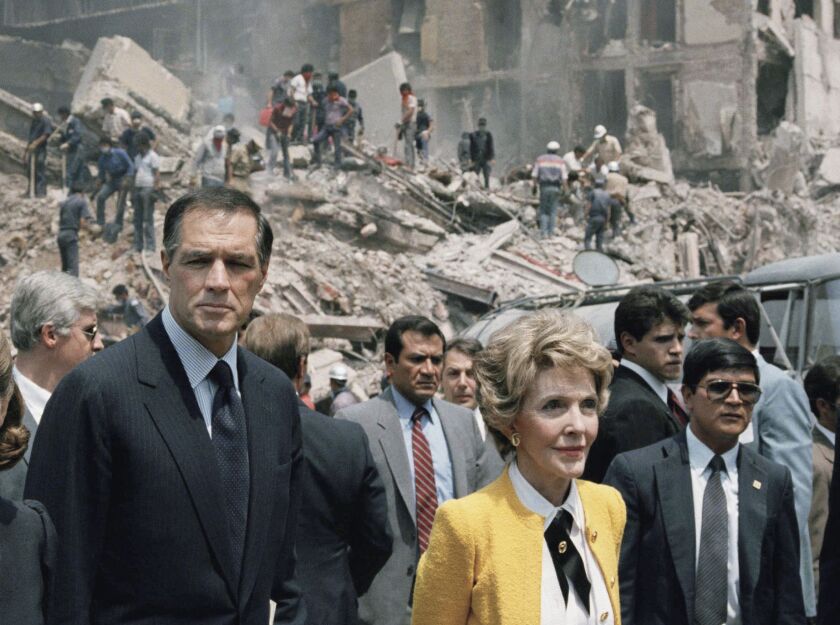 In this Sept. 24, 1985 file photo, First Lady Nancy Reagan and U.S. Ambassador to Mexico John Gavin (left) view earthquake damage in Mexico City. | AP Photo/Bob Daugherty, File
