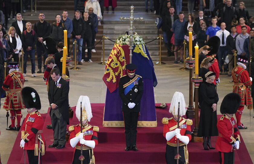 Queen Elizabeth II ‘s grandchildren (clockwise from front center): Prince William, the Prince of Wales, Peter Phillips, James, Viscount Severn, Princess Eugenie, Prince Harry, the Duke of Sussex, Princess Beatrice, Lady Louise Windsor and Zara Tindall bow during the vigil of the Queen’s grandchildren, as they stand by the coffin of Queen Elizabeth II, as it lies in state in Westminster Hall.