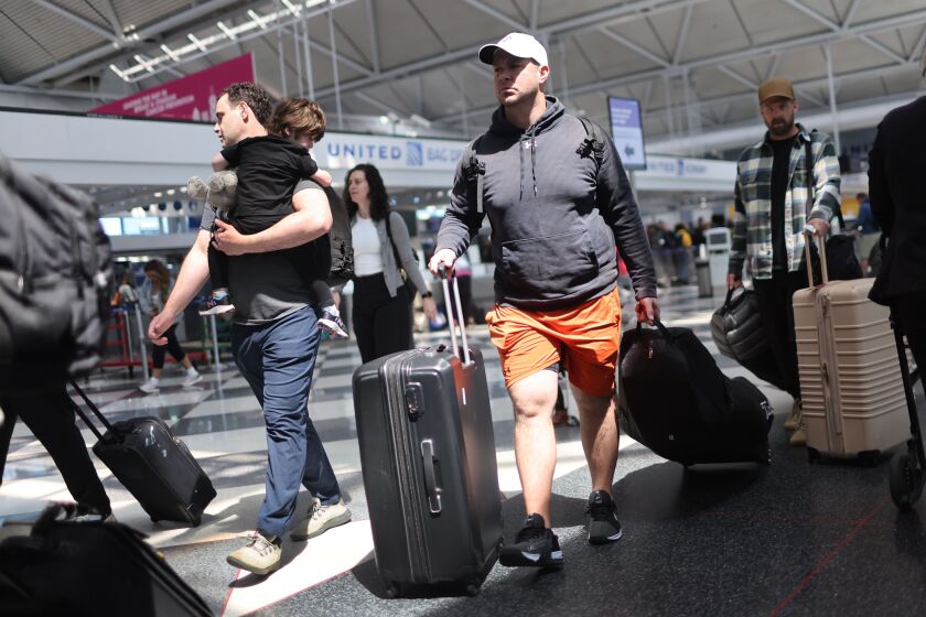 Travelers at O’Hare Airport in May.