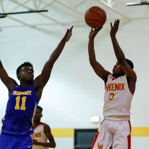 North Lawndale’s Daveon Rogers (3) shoots the ball past Farragut’s Mikell Jones (11).