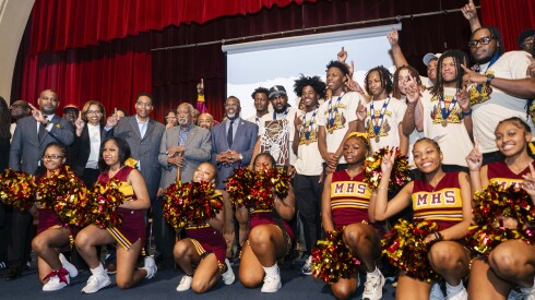 Members of the Marshall High School basketball team, called the Marshall Commandos, pose with school and local officials during a celebration for them at John Marshall Metropolitan High School in Garfield Park, Thursday, April 2, 2026. The team won the won the Illinois High School Association Class 1A state championship in March.