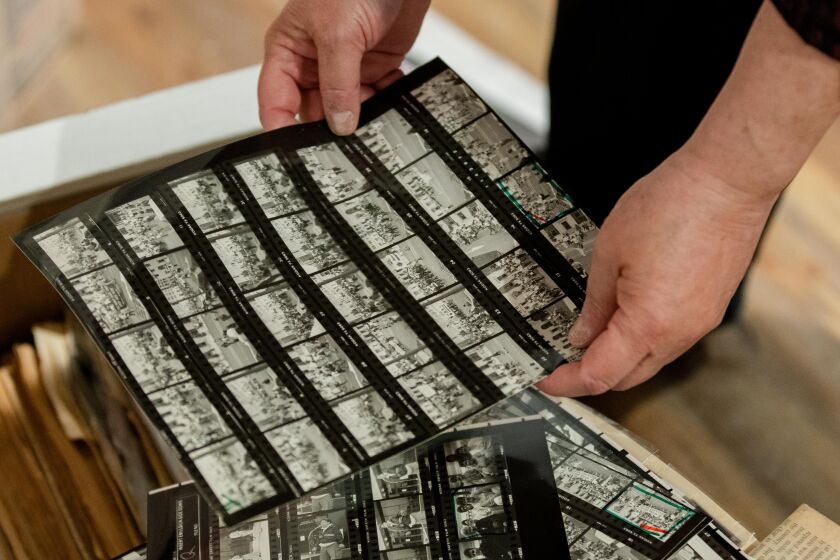 Tracy Baim, co-founder of Windy City Times and co-publisher of Chicago Reader, shows negatives that weren’t printed in Windy City Times in her home in the Portage Park neighborhood, Friday morning, April 9, 2021.