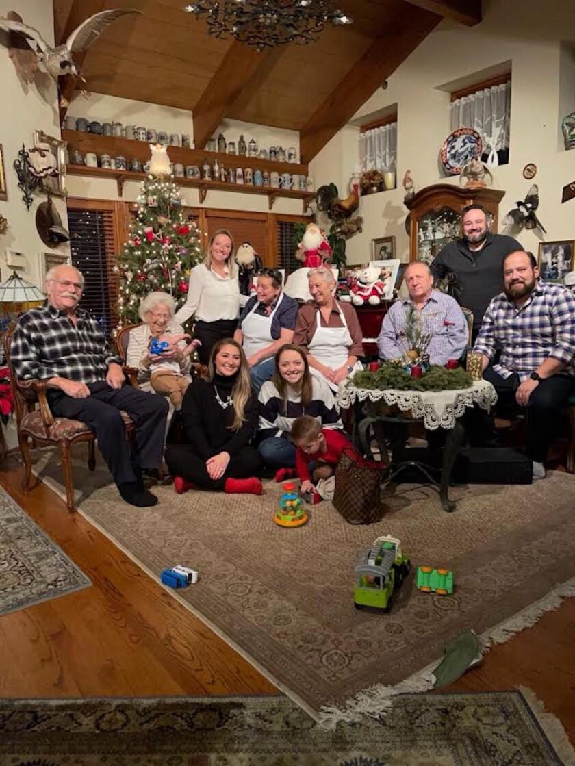 Erich and Inge Himmel (left) celebrate Christmas as a family at their Lincoln Square home. Mr. Himmel designed and helped build the house with Bavarian touches.