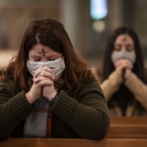 Congregants pray after receiving the imposition of ashes from Father Tom Hurley at Old St. Patrick’s Catholic Church on the Near West Side on Ash Wednesday, Feb. 17, 2021.