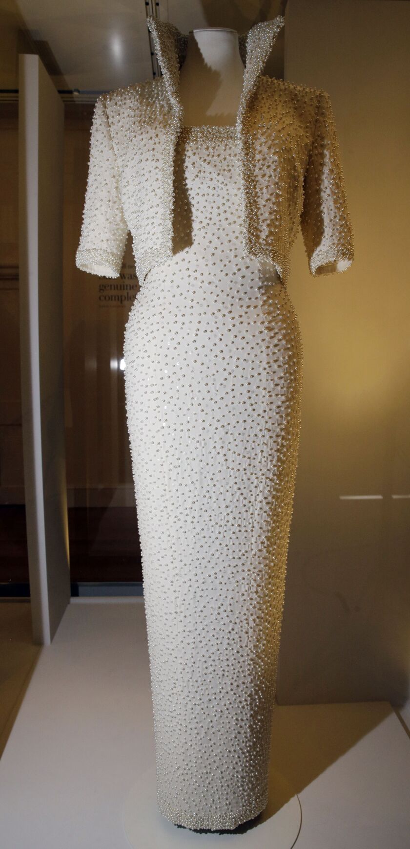 An evening dress by Catherine Walker of white silk crepe and a sequin and pearl embroidered jacket was worn by Diana, Princess of Wales, on an official visit to Hong Kong 1989. (AP Photo/Alastair Grant)