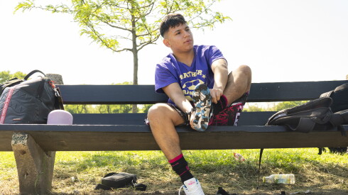 Ricardo Navarrete laces up his soccer shoes.