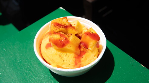A fresh cup of mangonada, a mango ice dessert, sits on the counter of Esperanza Kitchen Delights at Taste of Chicago.