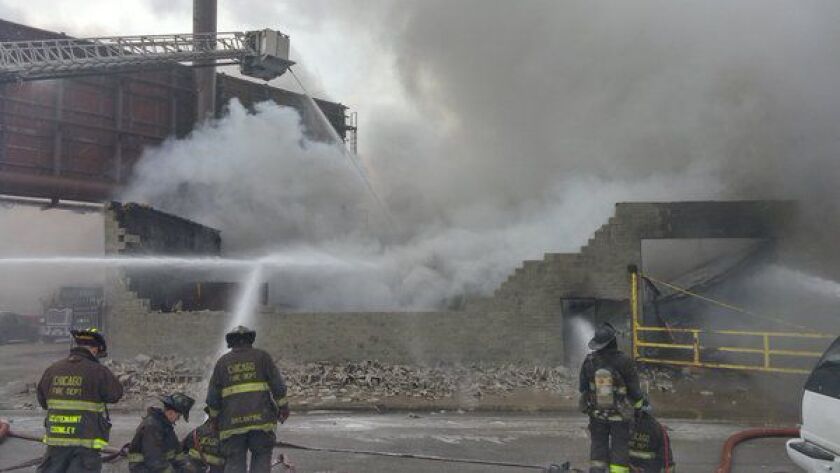 A smoky fire is raging at body shop in the Greater Grand Crossing neighborhood Tuesday morning. | Fire Media