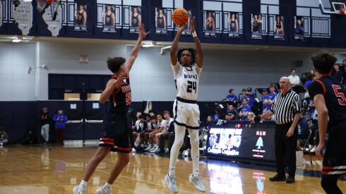 Oswego East's Mason Lockett (24) shoots a three against Oswego.