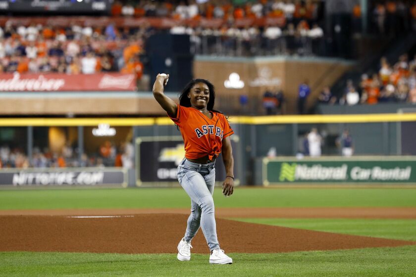 Gymnast Simone Biles throws out the ceremonial first pitch prior to game two of the 2019 World Series between the Houston Astros and the Washington Nationals at Minute Maid Park in 2019 in Houston, Texas.