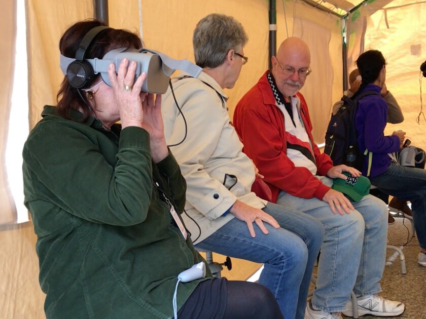 Visitors to the Forced From Home Exhibit use virtual reality headsets to experience what migrants from around the world go through to flee their countries. | Emily McTavish/Sun-Times