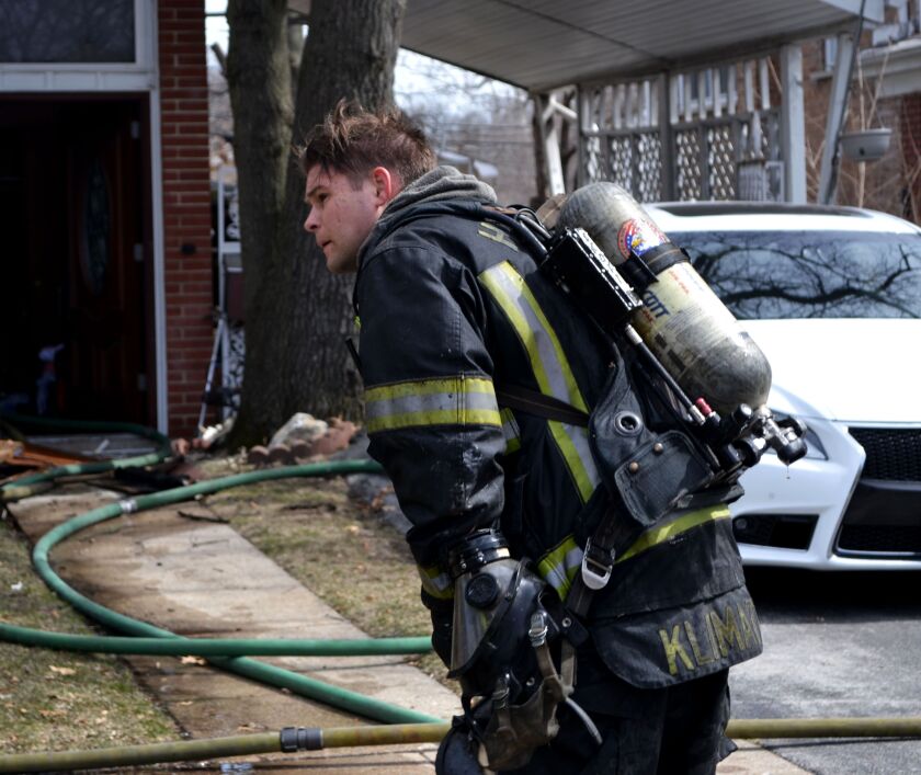 A firefighter responds to a blaze Sunday afternoon at a home in the 14800 block of Dobson Avenue in Dolton. | Justin Jackson/Sun-Times