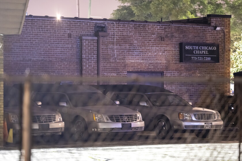 Hearses sit parked outside the South Chicago Chapel after decomposing bodies were found in the South Deering funeral home.