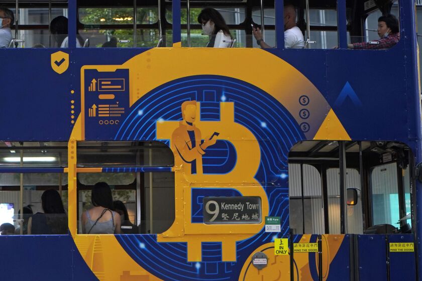 An advertisement for the cryptocurrency Bitcoin displayed on a tram in Hong Kong. Bitcoin is one of several cryptocurrencies that radical right provocateurs, banned by traditional financial institutions, are using to raise money and move it around the world.