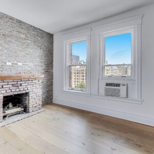 Bedroom with brick wall and fireplace