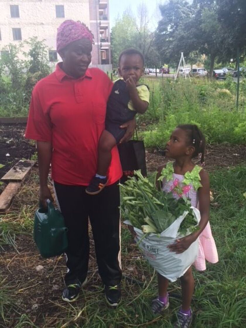 Martha Itulya-Omollo shown with her children. | Photo provided by 65th & Woodlawn Garden Committee