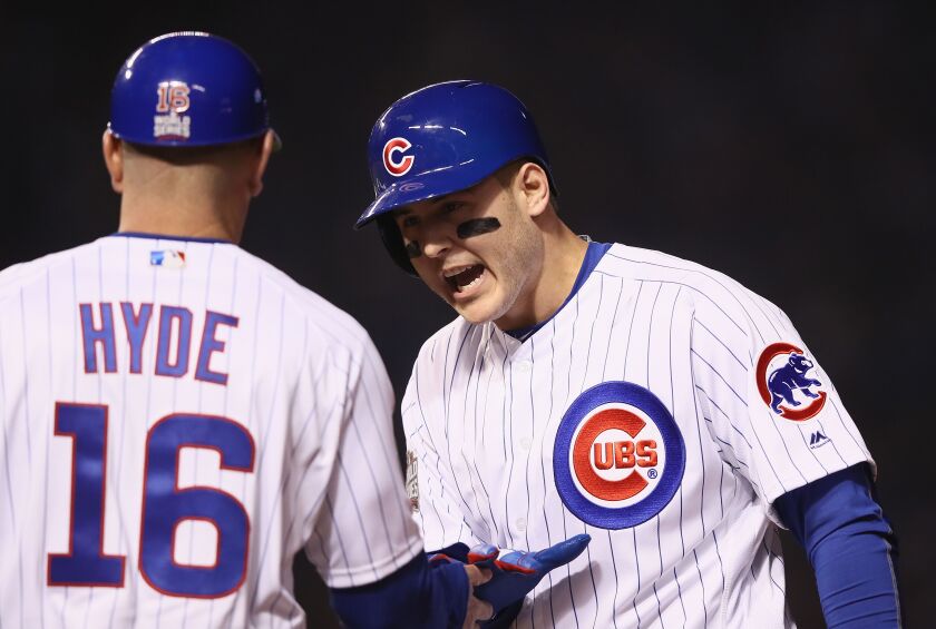 <em>Anthony Rizzo celebrates with first base coach Brandon Hyde after driving in the Cubs’ first run in the first ining. (Getty Images)</em>