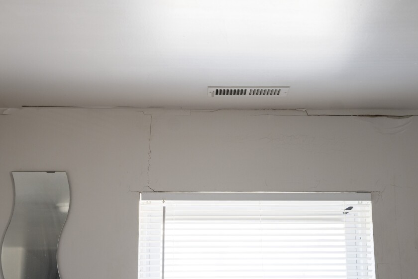 Cracks in the ceiling and along the wall in the living room of Willie Wright.