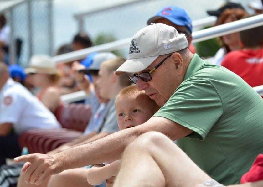 Richard Jaworowski in 2016 with his youngest grandson, Owen, teaching him about baseball at a high school game in Cedar Lake, Ind.