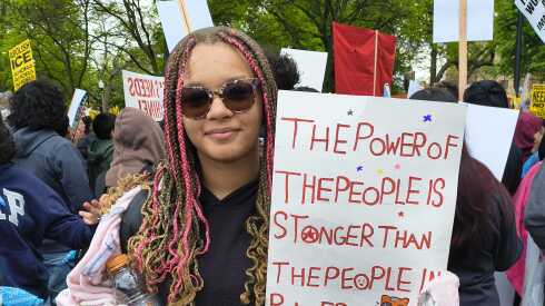 A student holds a sign at the May Day rally in Chicago.