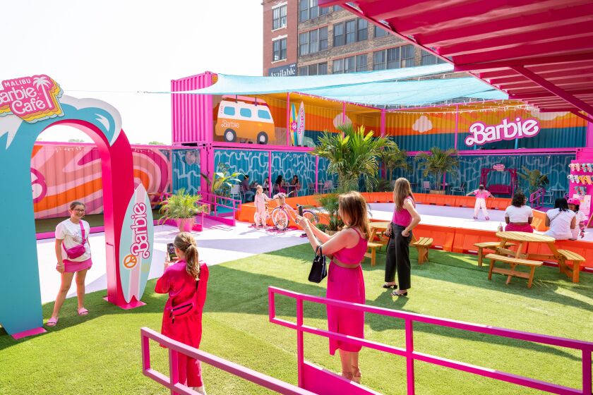 Patrons take advantage of photo ops in the outdoor area of the Malibu Barbie Cafe pop-up in the West Loop.