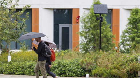Students walk by a Flock camera on the University of Illinois campus.