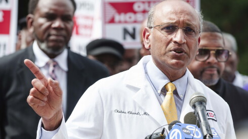 Dr. Vishnu Chundi, an infectious disease doctor, speaks during a rally with dozens of religious leaders, health care workers and community members outside West Suburban Medical Center in Austin to demand the reopening of the hospital, Tuesday, May 26, 2026.