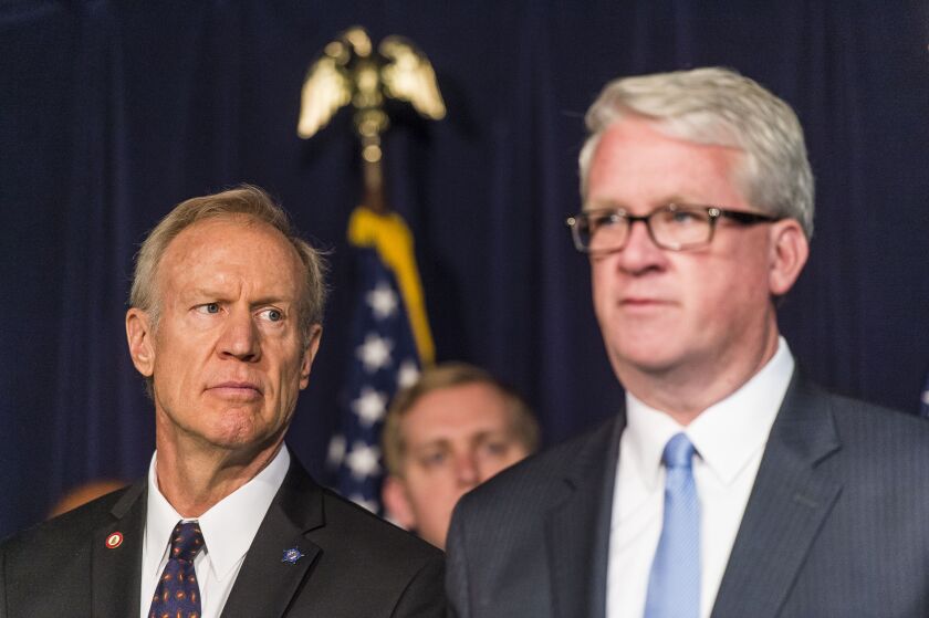 Illinois Governor Bruce Rauner (left) listens as State Representative Jim Durkin speaks to members of the media about the Illinois state budget for fiscal year 2019.
