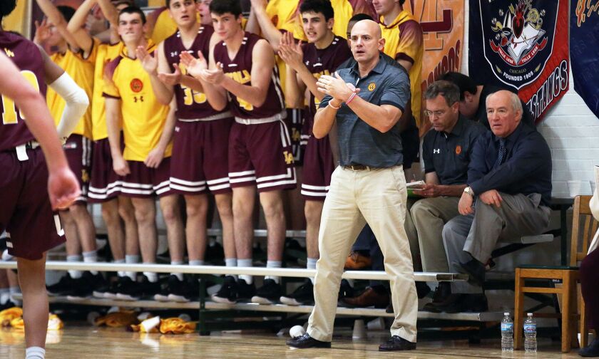 Loyola’s bench and head coach Tom Livatino applaud a three-point bucket last season.
