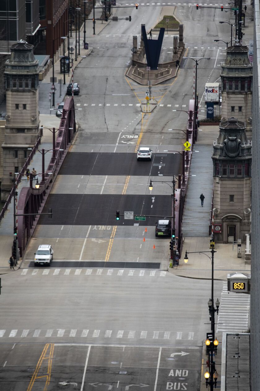 Amid fears of the coronavirus pandemic and a stay-at-home order from Gov. J.B. Pritzker, few pedestrians and minimal traffic could be seen in the Loop, looking north on North LaSalle Street from the roof of City Hall during the Wednesday morning commute, April 1, 2020.