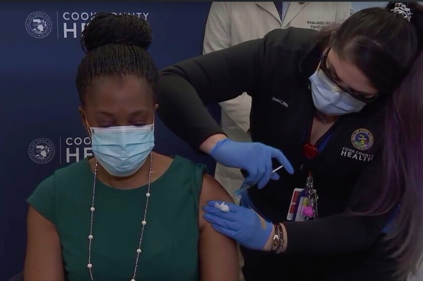 Illinois Public Health Director Dr. Ngozi Ezike receives her first dose of the coronavirus vaccine Tuesday at North Riverside Health Center.