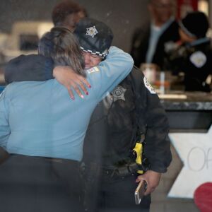 Police officers embrace at the Wentworth District police station Tuesday. | Scott Olson/Getty Images