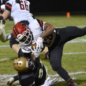 Yorkville’s Toran Harris (23) gets tackled by Richards. Worsom Robinson/For the Sun-Times.