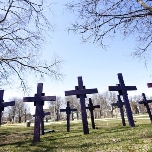 Crosses representing victims of gun violence stand outside Collins Academy High School in Chicago’s North Lawndale neighborhood. | AP Photo/Martha Irvine