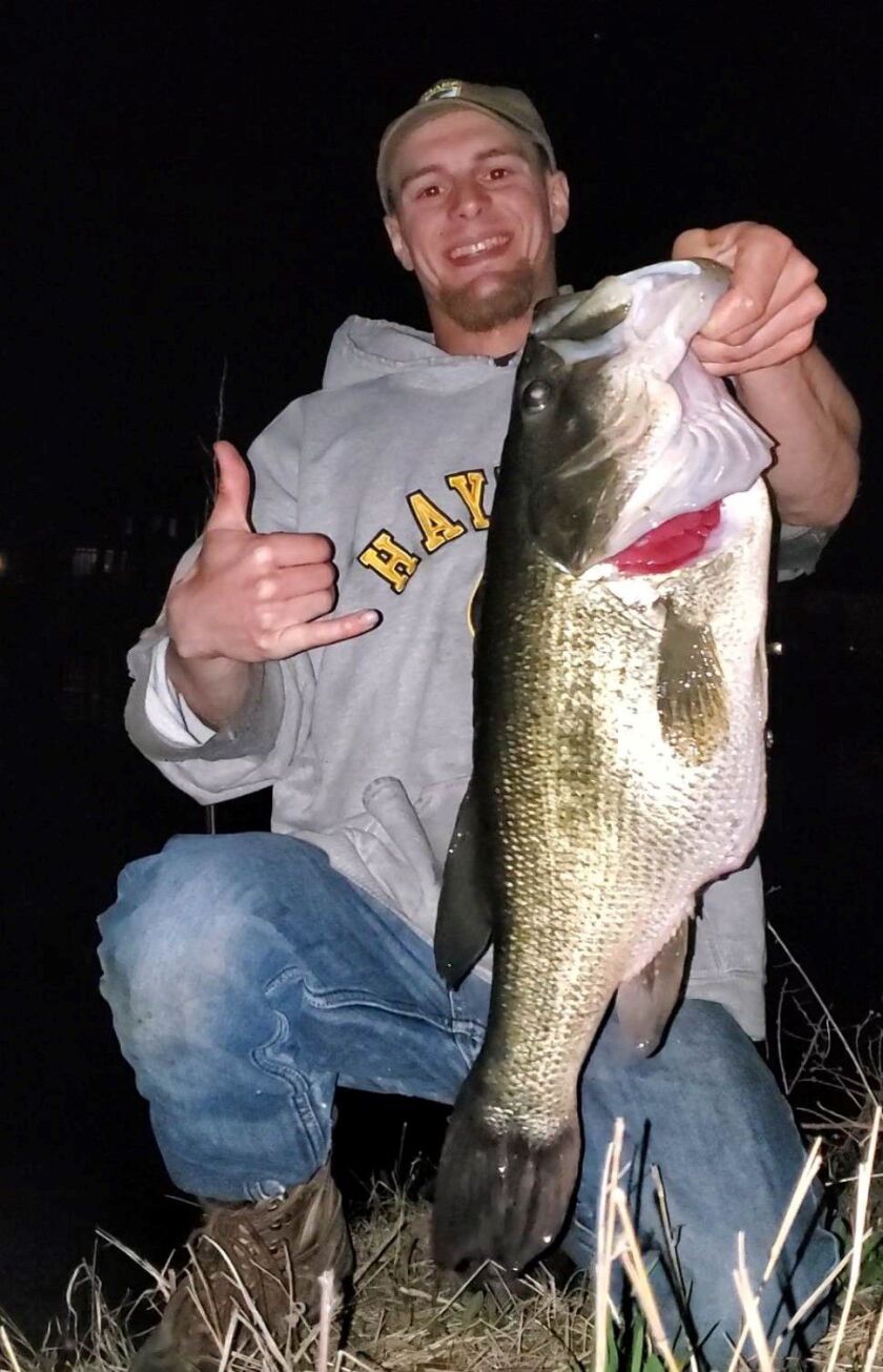 Another view of Scott Oglanian with his personal-best largemouth bass, caught at night in Cook County. Provided photo