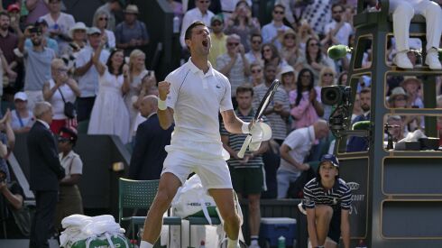 Novak Djokovic celebrates after beating Cam Norrie in a men’s singles semifinal at Wimbledon.