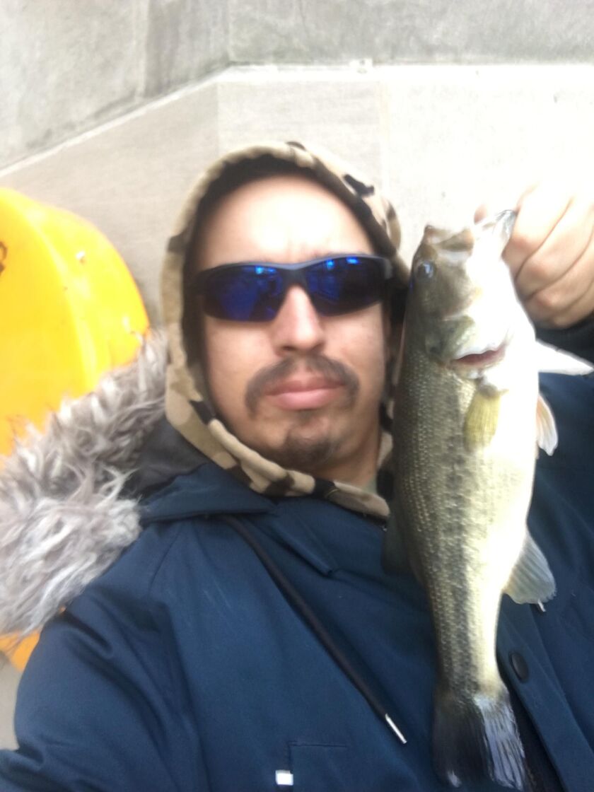 Jeffrey Williams with a Chicago River largemouth bass. Provided photo