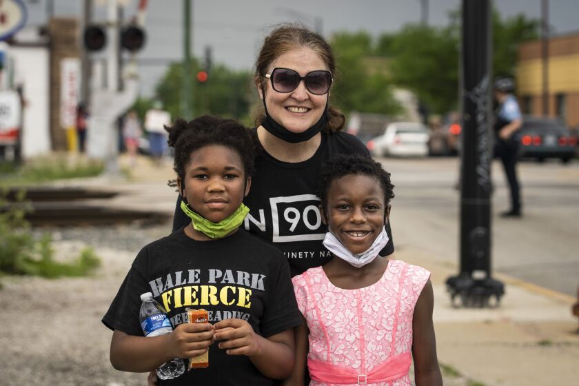 Bernadette O’Shea and her two daughters Lena and Kamariia at a Black Lives Matter rally and march Thursday through their neighborhood on the Southwest Side.