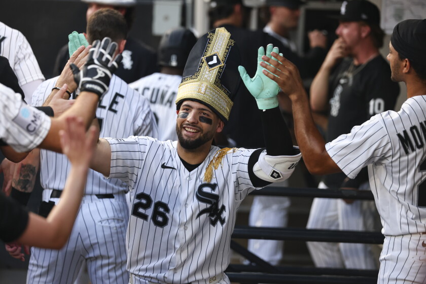 White Sox players donned the pope hat given away to fans at the Aug. 11 game to celebrate home runs vs. the Cincinnati Reds.